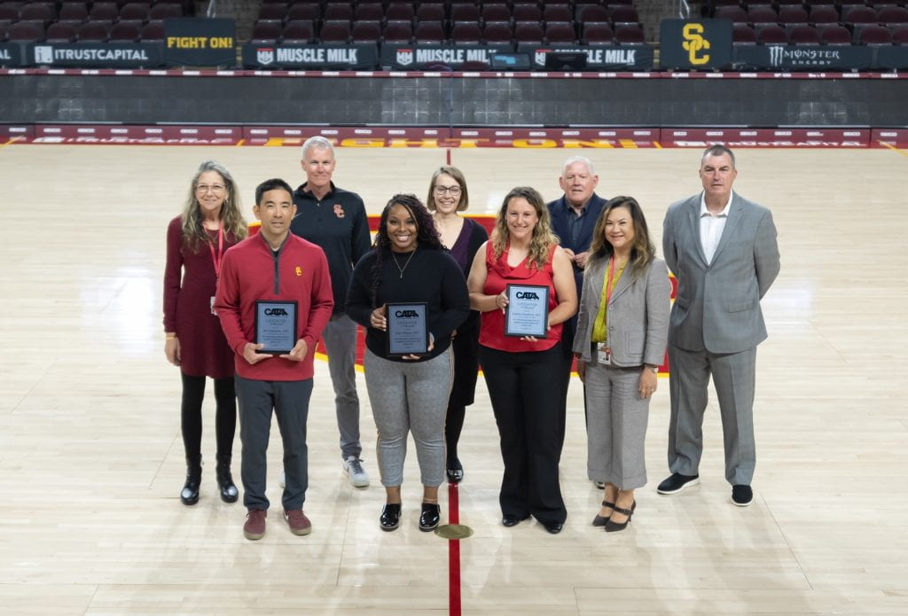Front row: Athletic trainers and award honorees Jon Yonamine, Erin Tillman, and Lauren Crawford with Thu Nguyen-Knowles (director of clinical operations, USC Student Health) Back row: Dr. Mildred Wenger (co-medical director, USC Student Health), Coach Andy Enfield (head coach, Men’s Basketball), Dr. Sarah Van Orman (chief health officer, USC Student Health), Ky Kugler (CATA president), Russ Romano, (director of operations, Athletic Medicine Dept. of USC Student Health)